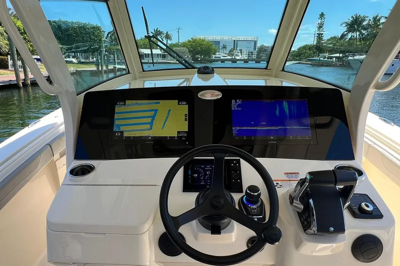  Yacht Photos Pics 2024 Scout 355 LXF boat helm with dual navigation screens and steering wheel.
