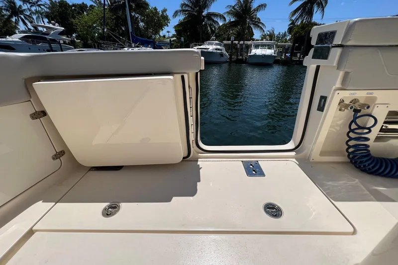  Yacht Photos Pics 2024 Scout 355 LXF boat deck with open hatch and water view.
