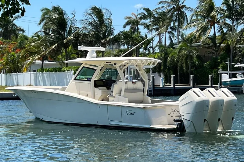  Yacht Photos Pics 2024 Scout 355 LXF boat with triple outboard engines on a sunny day.