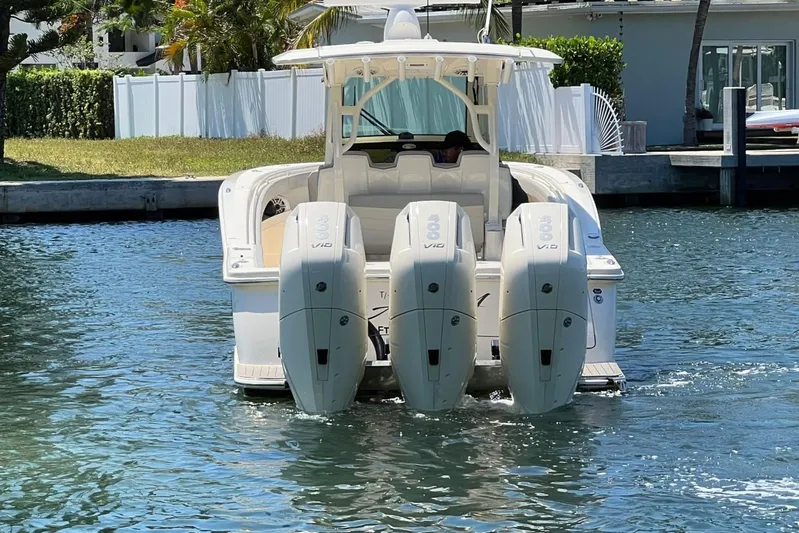  Yacht Photos Pics 2024 Scout 355 LXF boat with triple outboard engines on the water.