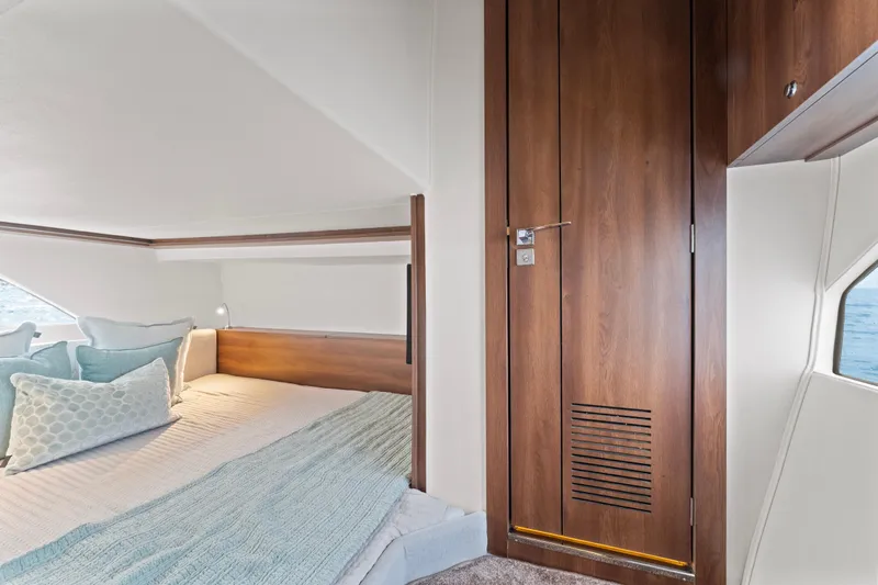  Yacht Photos Pics Luxurious cabin interior of 2025 Valiatt 380GT yacht with elegant wood finish and cozy bedding.