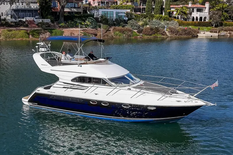 Phantom 42 Yacht Photos Pics 1998 Fairline Phantom 42 yacht cruising on a serene waterway.