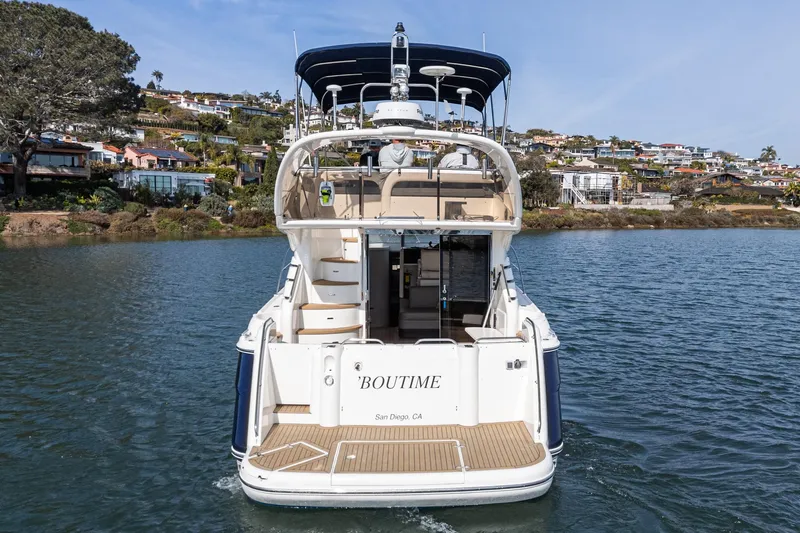 Phantom 42 Yacht Photos Pics 1998 Fairline Phantom 42 yacht on water, rear view, with coastal houses in background.