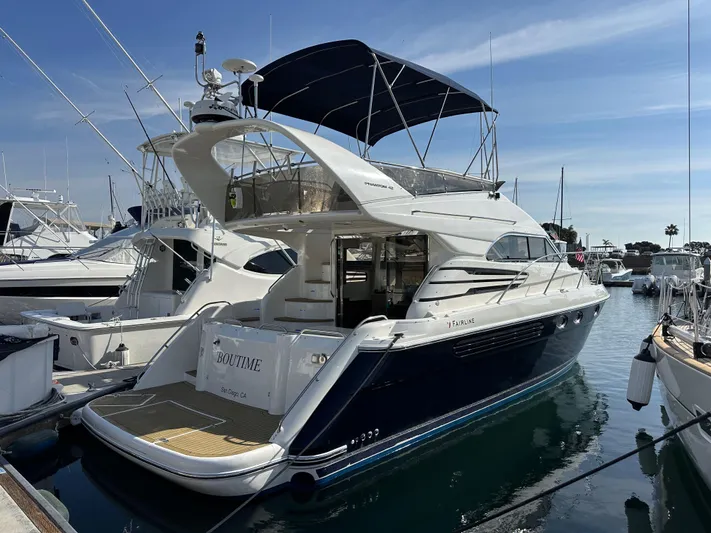 Phantom 42 Yacht Photos Pics 1998 Fairline Phantom 42 yacht docked at marina, featuring sleek design and spacious deck.