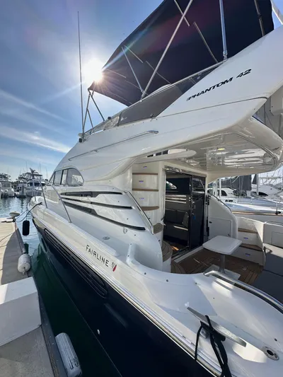 Phantom 42 Yacht Photos Pics 1998 Fairline Phantom 42 yacht docked under sunny skies.