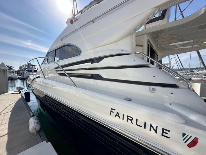 Phantom 42 Yacht Photos Pics 1998 Fairline Phantom 42 yacht docked at marina under clear sky.