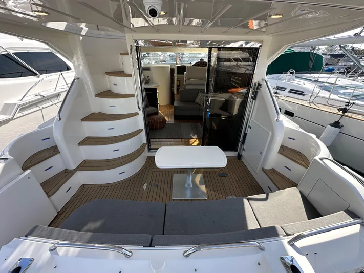 Phantom 42 Yacht Photos Pics 1998 Fairline Phantom 42 yacht interior with seating, table, and stairs, showcasing luxury design.