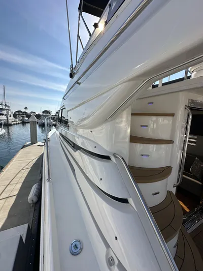 Phantom 42 Yacht Photos Pics 1998 Fairline Phantom 42 yacht docked, showcasing sleek design and elegant stairway.