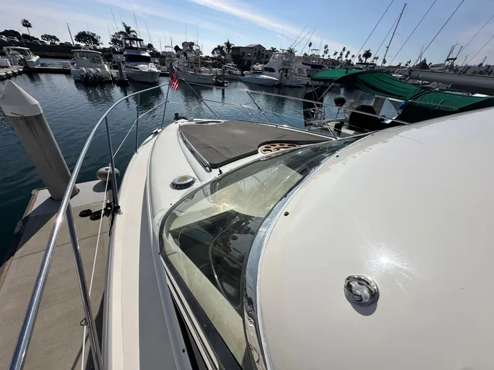 Phantom 42 Yacht Photos Pics 1998 Fairline Phantom 42 yacht docked in a marina, showcasing sleek design and spacious deck.