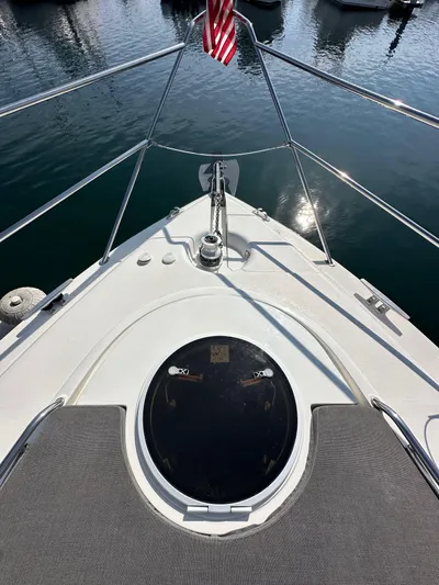 Phantom 42 Yacht Photos Pics 1998 Fairline Phantom 42 yacht bow with American flag, docked on calm water.