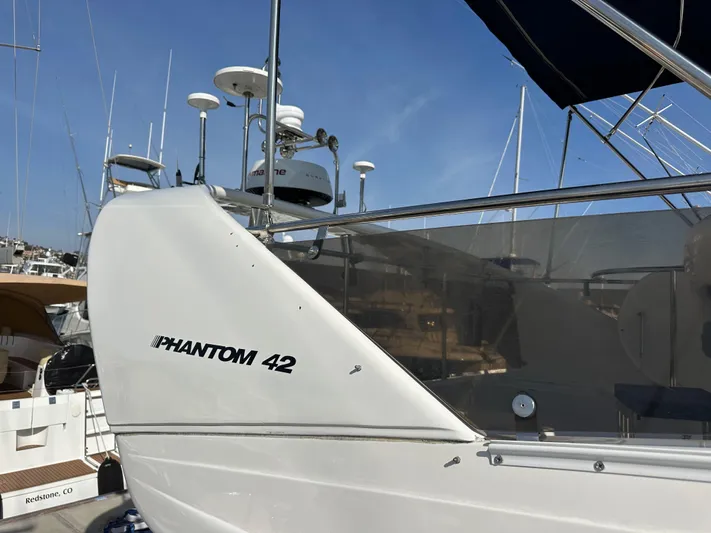 Phantom 42 Yacht Photos Pics 1998 Fairline Phantom 42 yacht docked at marina, showcasing sleek design and modern equipment.