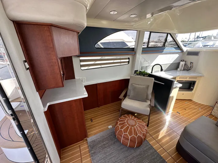 Phantom 42 Yacht Photos Pics Interior of 1998 Fairline Phantom 42 yacht with modern furnishings and wooden flooring.