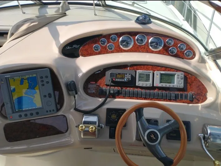 Cdog Yacht Photos Pics 2001 Sea Ray 380 Sundancer dashboard with navigation equipment and steering wheel.