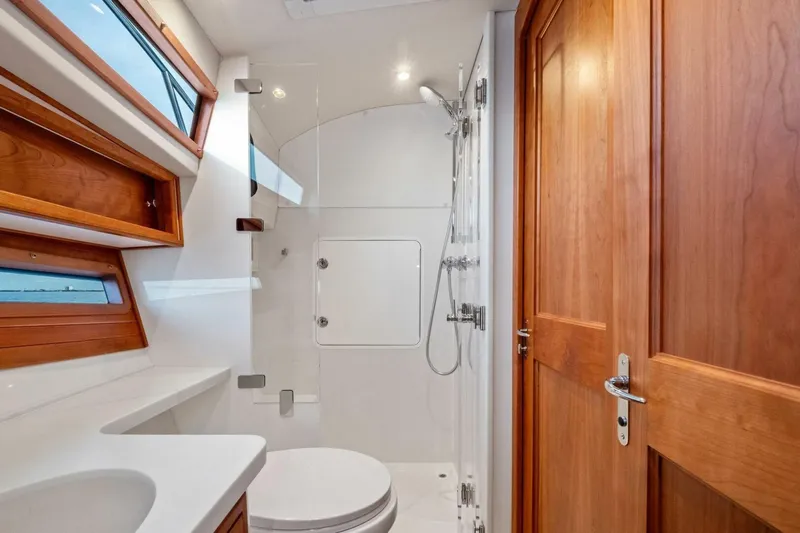  Yacht Photos Pics Luxurious bathroom in 2025 MJM 42 yacht with wooden accents and modern fixtures.