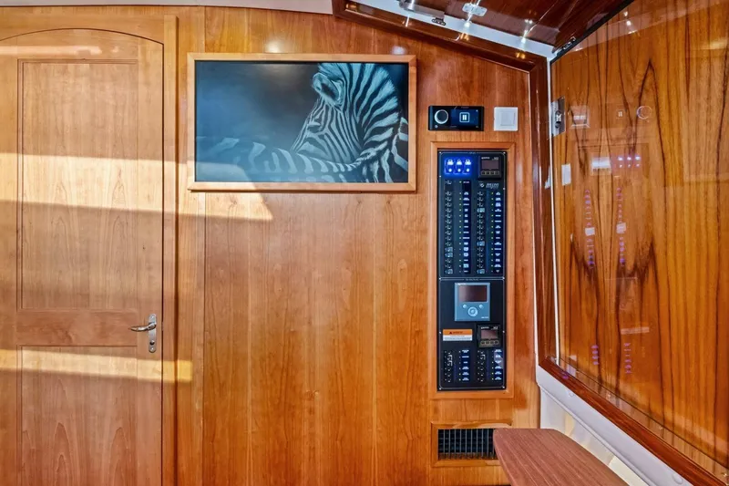  Yacht Photos Pics Interior of 2025 MJM 42 yacht with wood paneling and control panel.