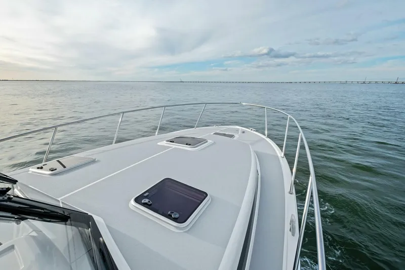  Yacht Photos Pics 2025 MJM 42 yacht cruising on open water under a cloudy sky.