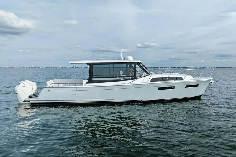  Yacht Photos Pics 2025 MJM 42 boat on calm water, featuring sleek design and modern outboard engines.