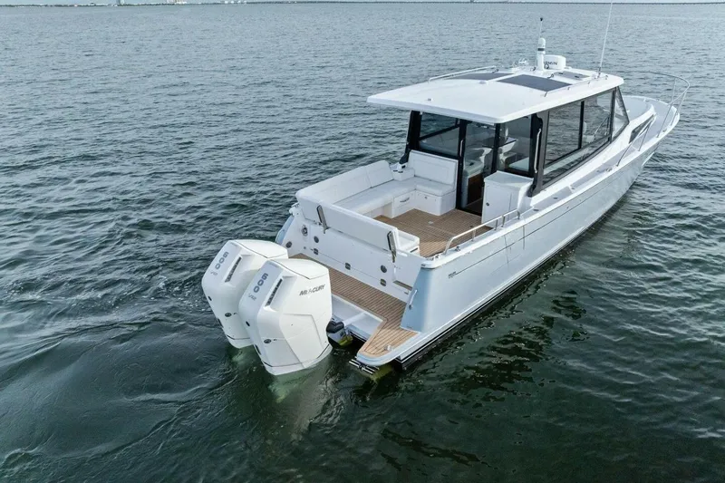  Yacht Photos Pics 2025 MJM 42 boat with dual outboard engines on calm water.