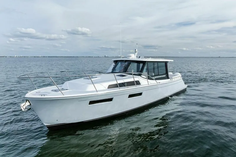  Yacht Photos Pics 2025 MJM 42 yacht cruising on open water under a cloudy sky.