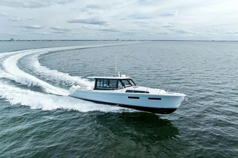  Yacht Photos Pics 2025 MJM 42 yacht cruising on open water, creating a dynamic wake.