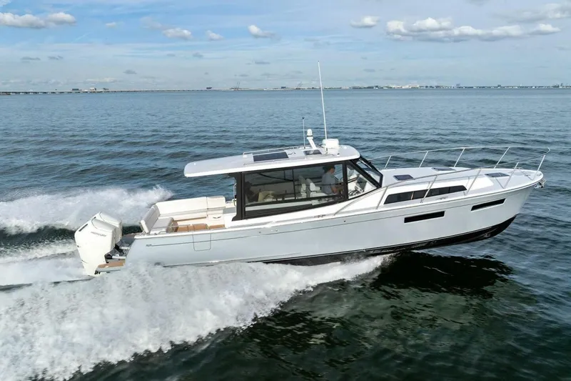  Yacht Photos Pics 2025 MJM 42 boat cruising on open water under a clear sky.