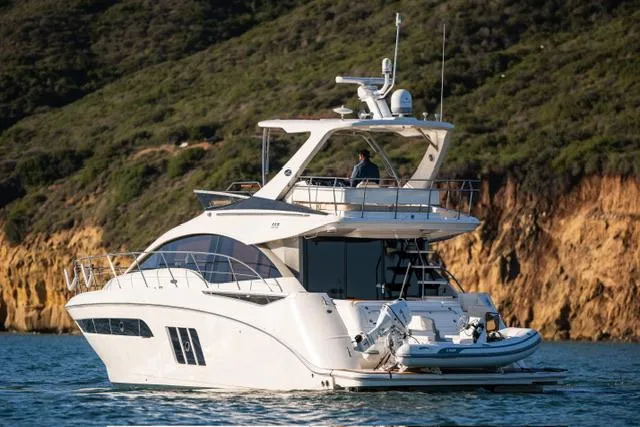  Yacht Photos Pics 2015 Sea Ray 510 Fly yacht cruising near rocky coastline.