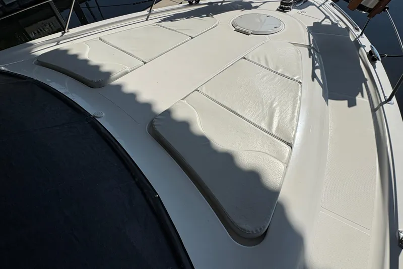  Yacht Photos Pics 2002 Carver 506 Motor Yacht deck with cushioned seating and hatch.