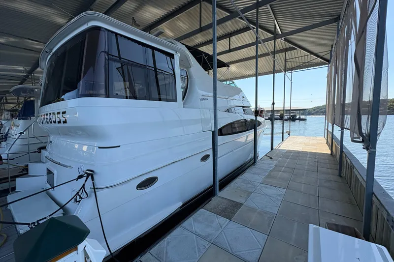  Yacht Photos Pics 2002 Carver 506 Motor Yacht docked in a covered marina with scenic water view.