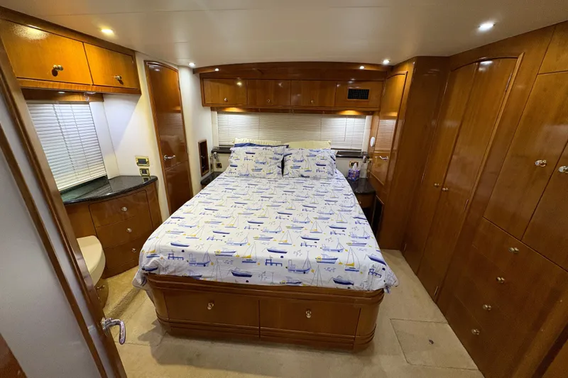  Yacht Photos Pics Luxurious bedroom in 2002 Carver 506 Motor Yacht with nautical-themed bedding.