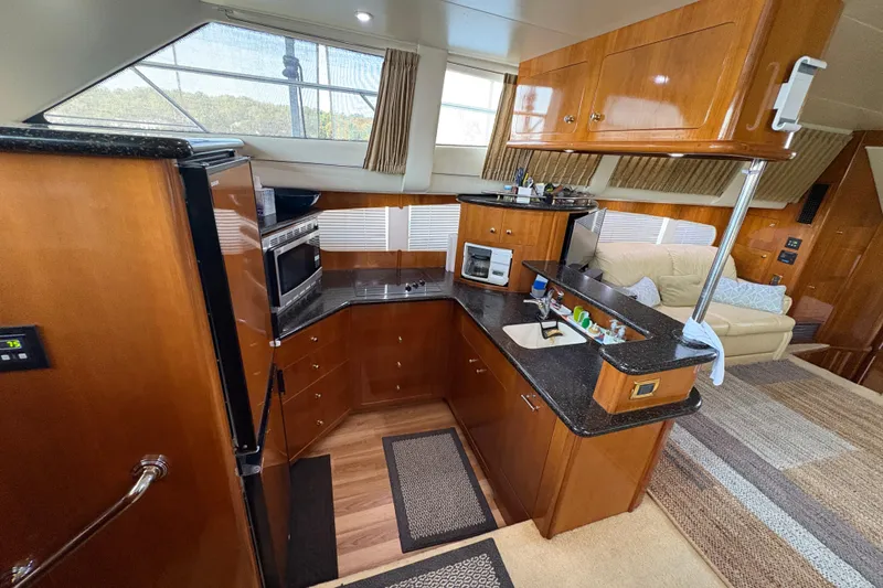  Yacht Photos Pics Luxurious interior of 2002 Carver 506 Motor Yacht with modern kitchen and seating area.