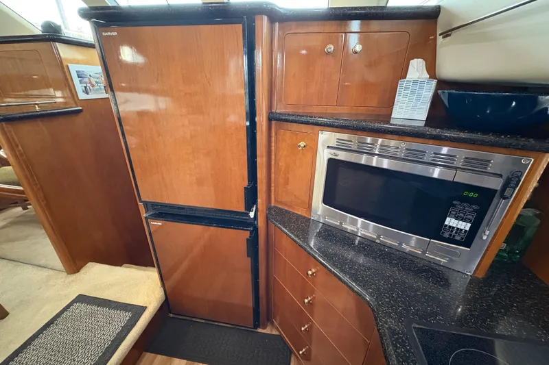  Yacht Photos Pics Interior of 2002 Carver 506 Motor Yacht kitchen with fridge and microwave.