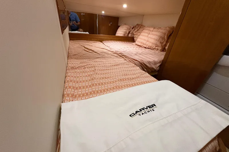  Yacht Photos Pics Cozy bedroom in 2002 Carver 506 Motor Yacht with patterned bedding and branded linens.
