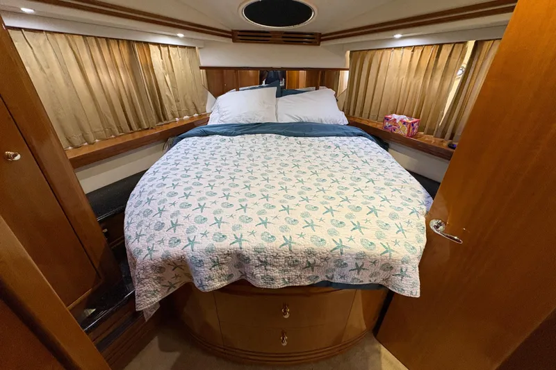  Yacht Photos Pics Cozy bedroom in 2002 Carver 506 Motor Yacht with nautical-themed bedding.