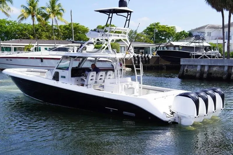  Yacht Photos Pics 2016 Everglades 435 Center Console boat with four engines docked in a marina.