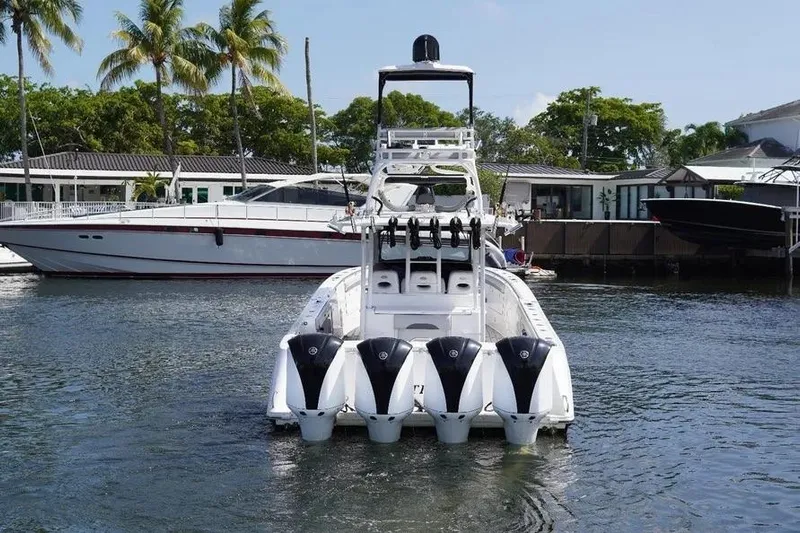  Yacht Photos Pics 2016 Everglades 435 Center Console boat with four engines docked in marina.