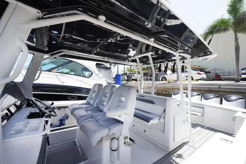  Yacht Photos Pics 2016 Everglades 435 Center Console boat interior with seating and helm, docked near palm trees.