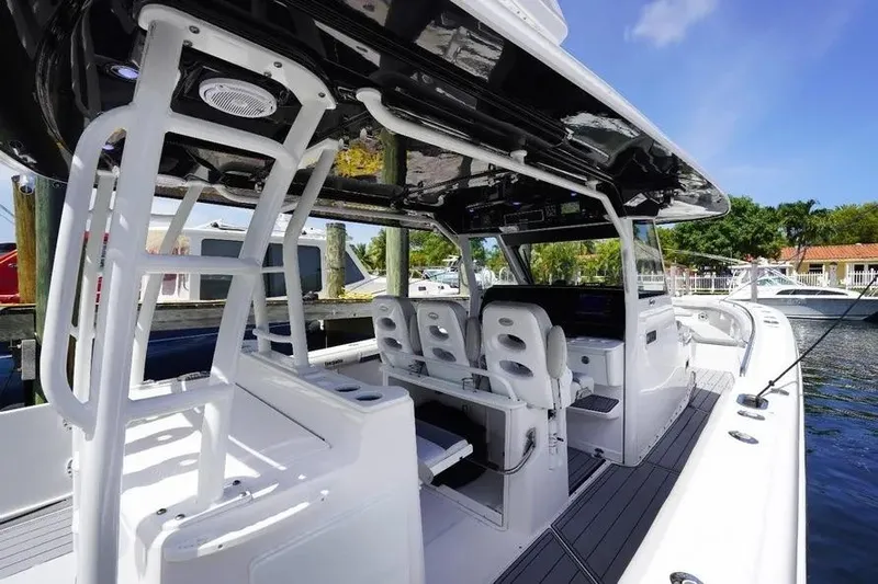  Yacht Photos Pics 2016 Everglades 435 Center Console boat interior with seating and helm, docked by the water.