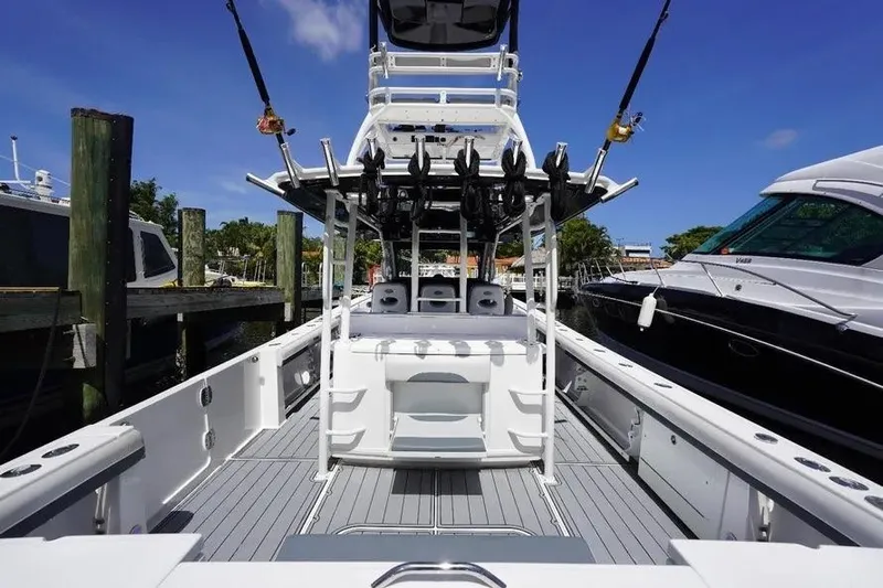  Yacht Photos Pics 2016 Everglades 435 Center Console boat docked, featuring fishing rods and spacious deck.