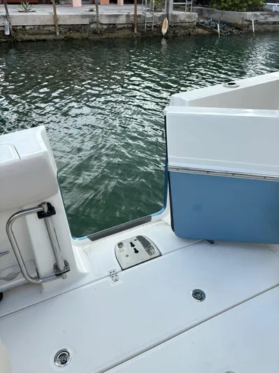 Demo Diamond Yacht Photos Pics 2017 Boston Whaler 420 Outrage boat deck with open side door by the water.