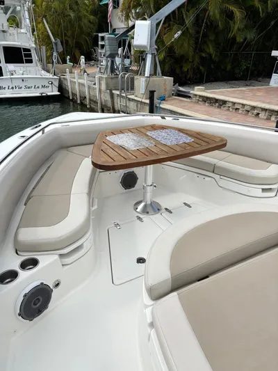 Demo Diamond Yacht Photos Pics 2017 Boston Whaler 420 Outrage boat interior with cushioned seating and wooden table.