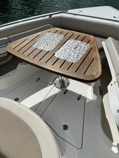 Demo Diamond Yacht Photos Pics Luxury seating area on 2017 Boston Whaler 420 Outrage with wooden table.