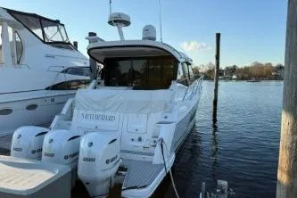  Yacht Photos Pics 2021 Regal 38 XO boat docked with triple outboard engines, calm water background.