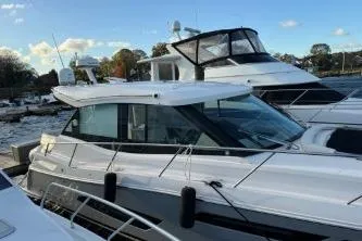  Yacht Photos Pics 2021 Regal 38 XO yacht docked at marina under clear sky.