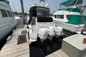  Yacht Photos Pics 2021 Regal 38 XO boat docked with triple outboard engines.