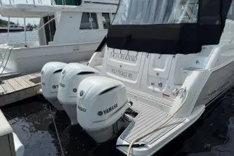  Yacht Photos Pics 2021 Regal 38 XO boat with Yamaha outboard engines docked at marina.