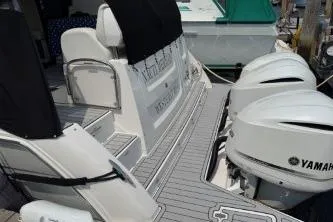  Yacht Photos Pics 2021 Regal 38 XO boat with Yamaha outboard engines, docked at a marina.