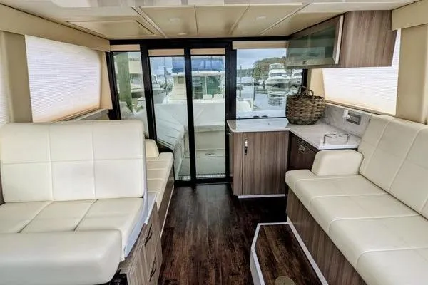  Yacht Photos Pics Luxurious interior of 2021 Regal 38 XO yacht with modern seating and kitchenette.