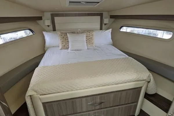  Yacht Photos Pics 2021 Regal 38 XO yacht interior bedroom with cozy bed and modern design.
