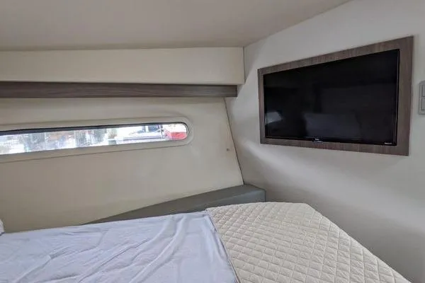  Yacht Photos Pics Interior cabin of 2021 Regal 38 XO yacht with bed and wall-mounted TV.