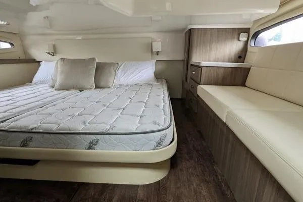  Yacht Photos Pics Luxurious interior of 2021 Regal 38 XO yacht with bed and seating area.
